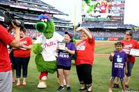 A Summer Reading star and nominating librarian smile for the jumbotron camera at Citizens Bank Park.
